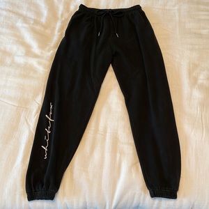 white fox black sweatpants, cursive writing on the bottom of the leg, size M